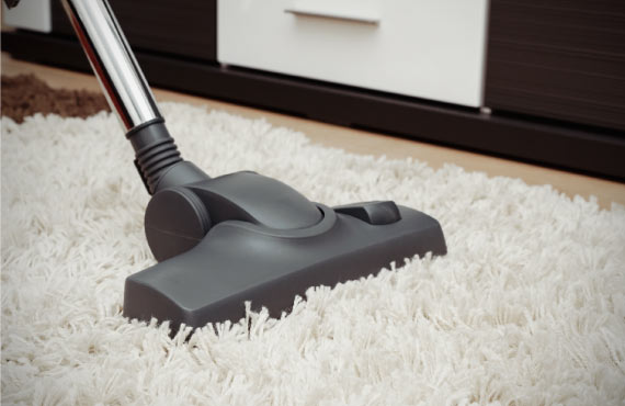 person vacuuming high pile rug
