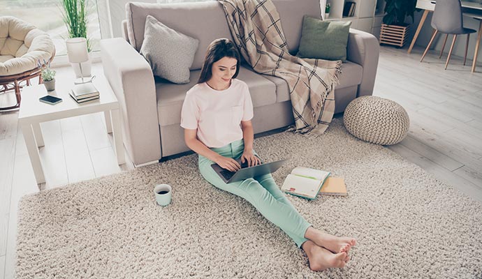 Person sitting on a clean and freshly repaired rug