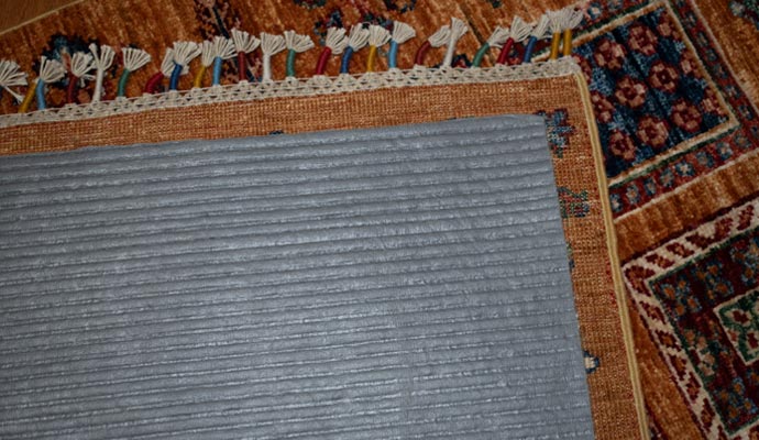 Close-up of rug pad under area rug