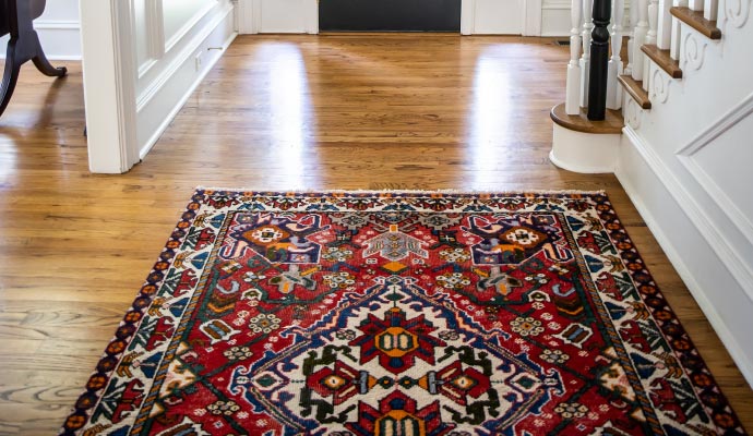 A rug placed on a beautiful hardwood floor room