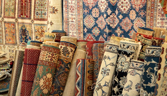 Rolled-up traditional rugs stored in a stack