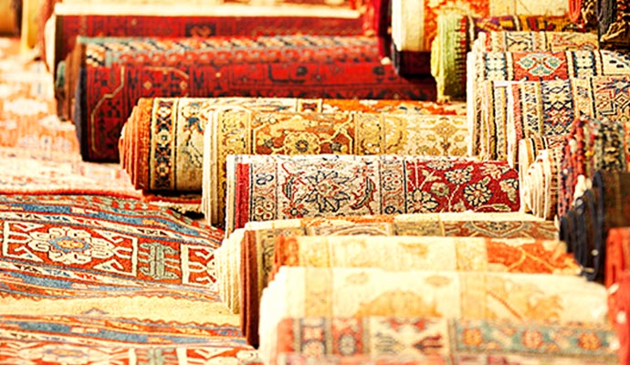 Rolled-up traditional rugs stored in a stack