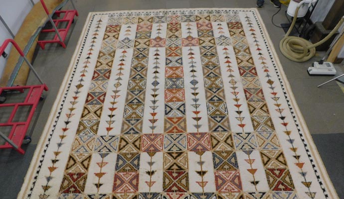 A geometric area rug on workshop floor