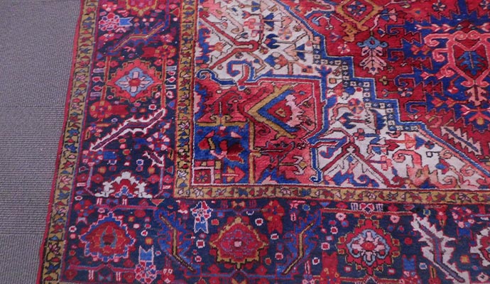 A detailed close-up of an antique Persian rug