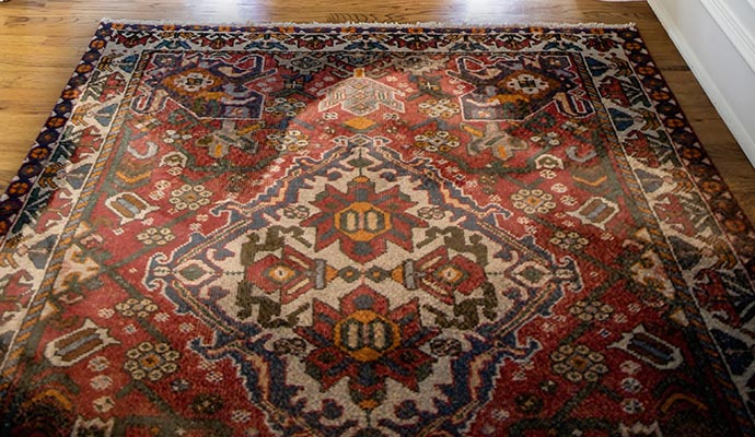 a dusty rug on the wooden floor