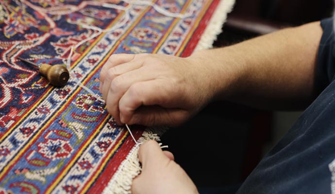 Person repairing a rug